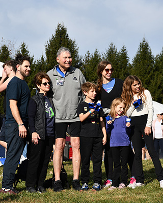 Dr. Weiner is surrounded by adult and child family members at the conclusion of his BellRinger ride